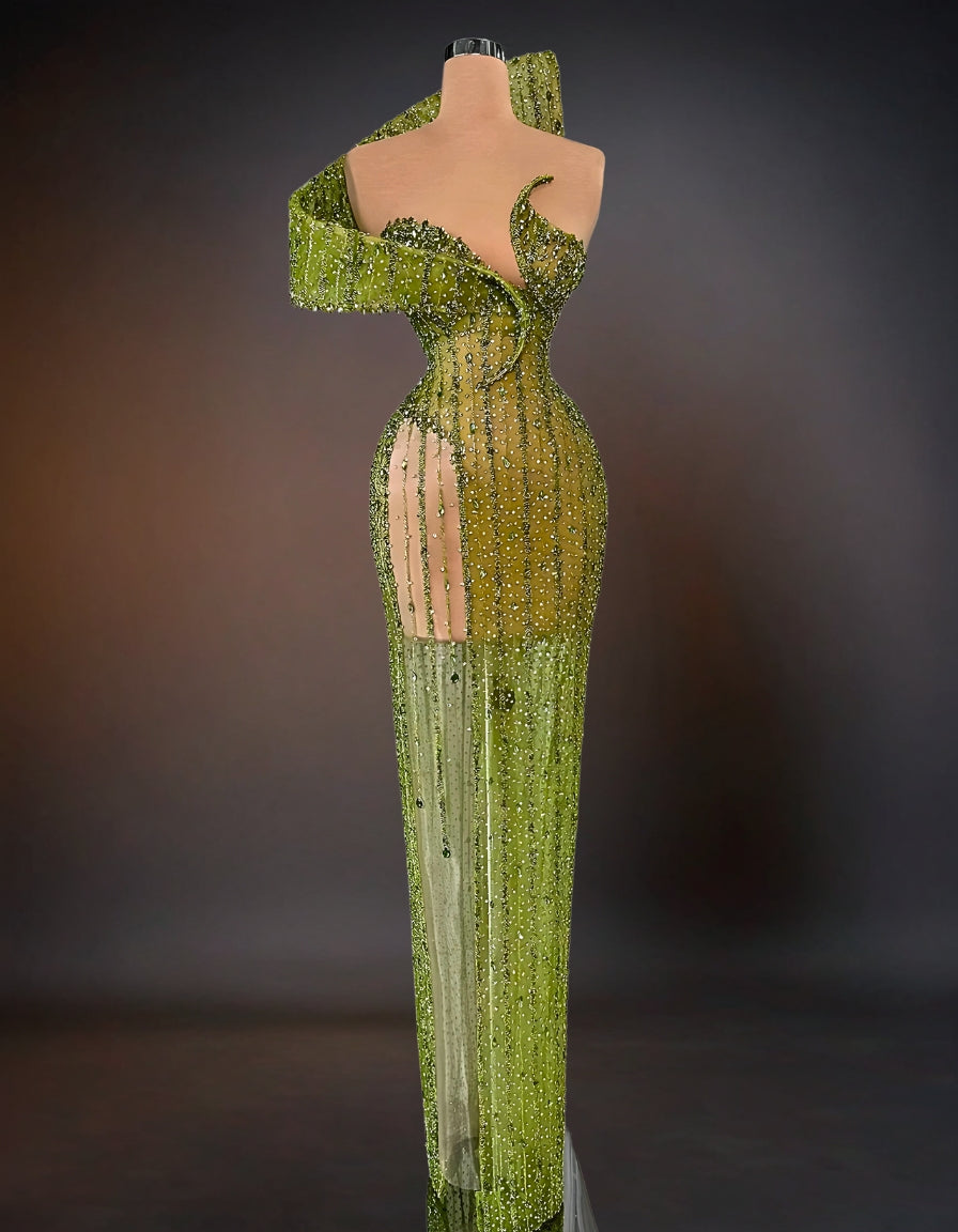 A luxurious green dress adorned with intricate stone embellishments.