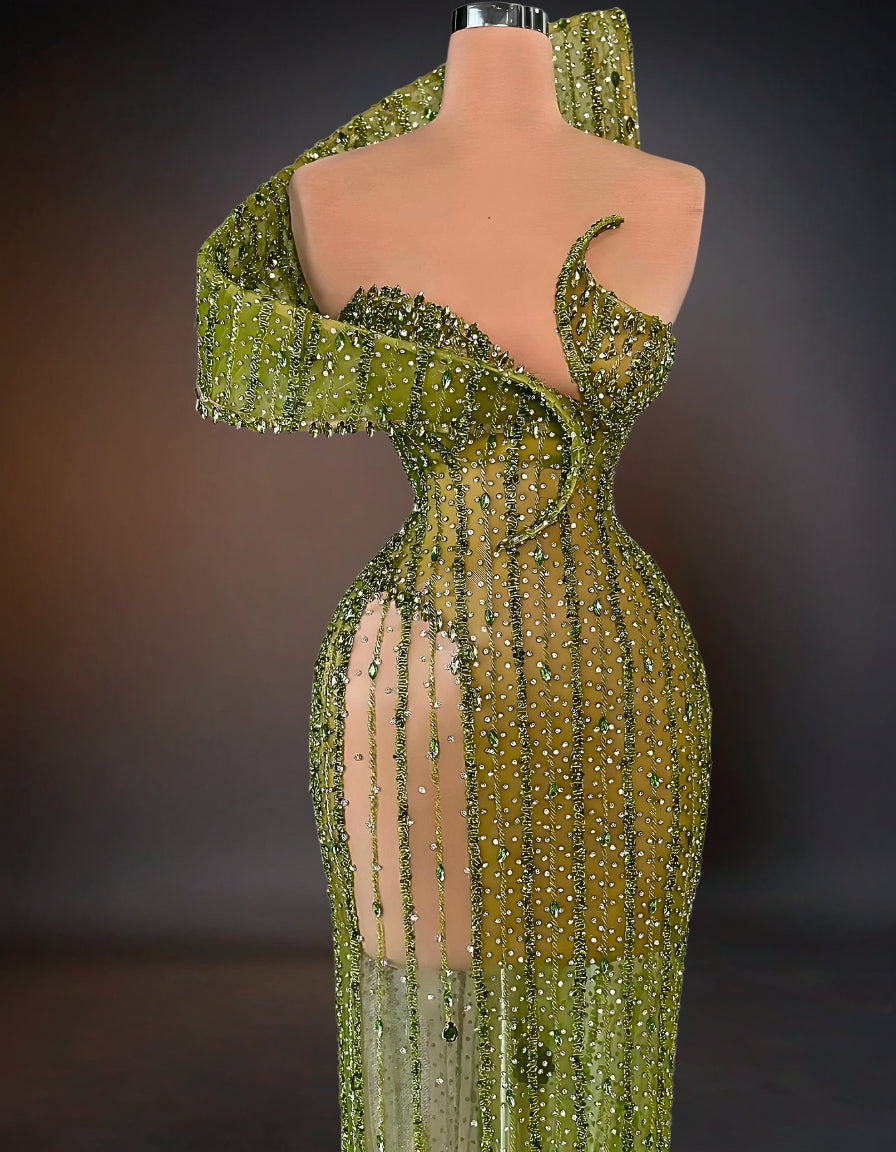 A luxurious green dress adorned with intricate stone embellishments.