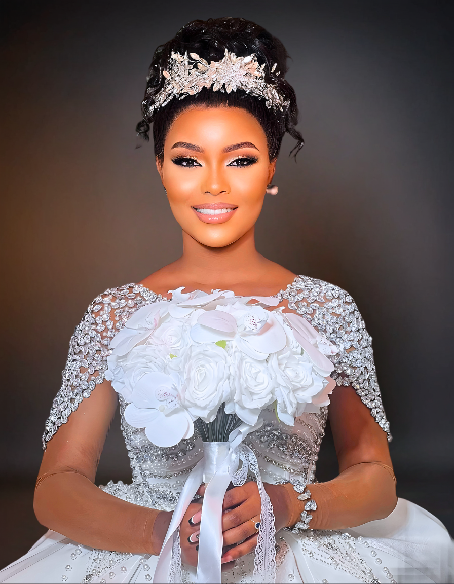 A luxurious mermaid wedding dress featuring a sheer neckline adorned with pearls. The dress includes a detachable skirt, adding versatility and elegance to the design.