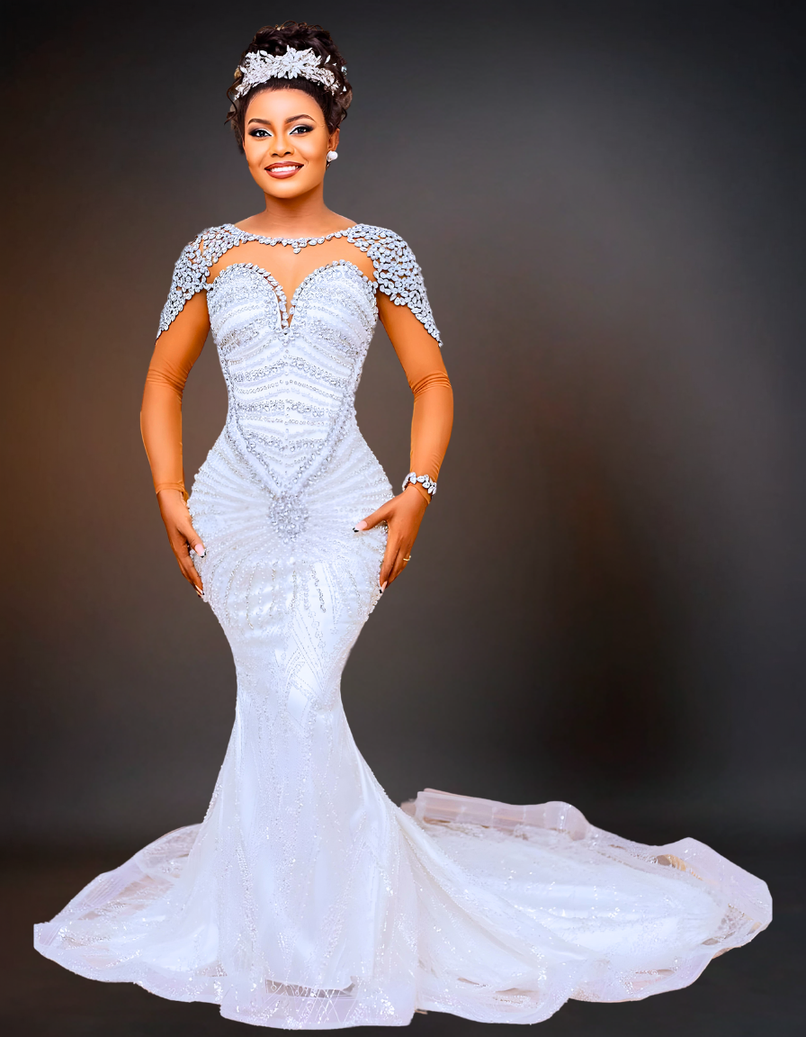 A luxurious mermaid wedding dress featuring a sheer neckline adorned with pearls. The dress includes a detachable skirt, adding versatility and elegance to the design.