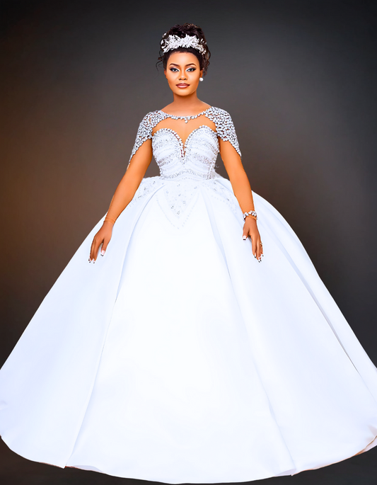 A luxurious mermaid wedding dress featuring a sheer neckline adorned with pearls. The dress includes a detachable skirt, adding versatility and elegance to the design.