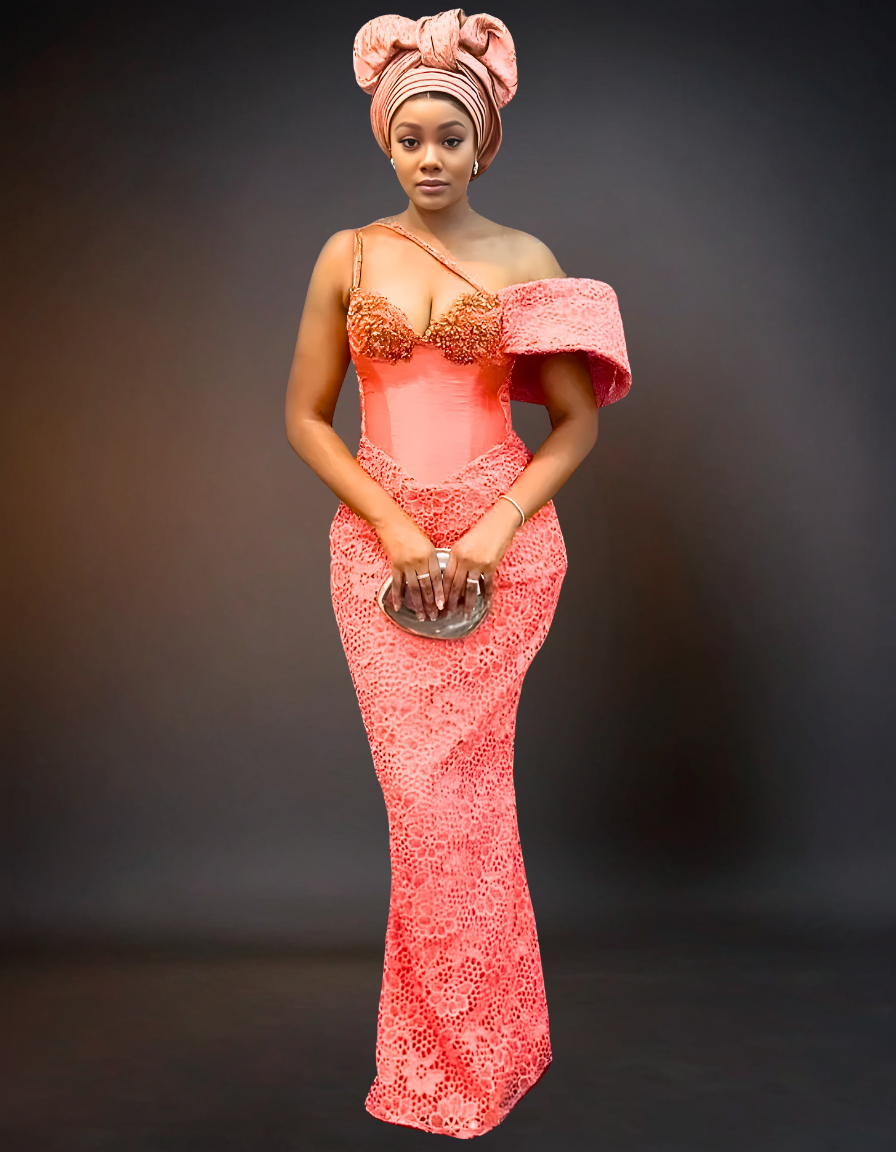 A luxury party dress in a soft peach color, featuring intricate beaded lace detailing.