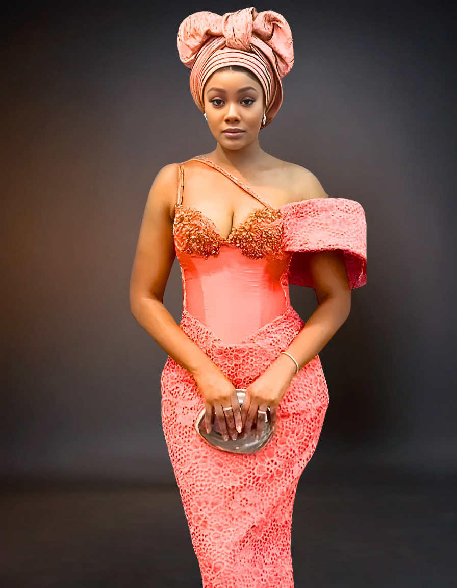 A luxury party dress in a soft peach color, featuring intricate beaded lace detailing.