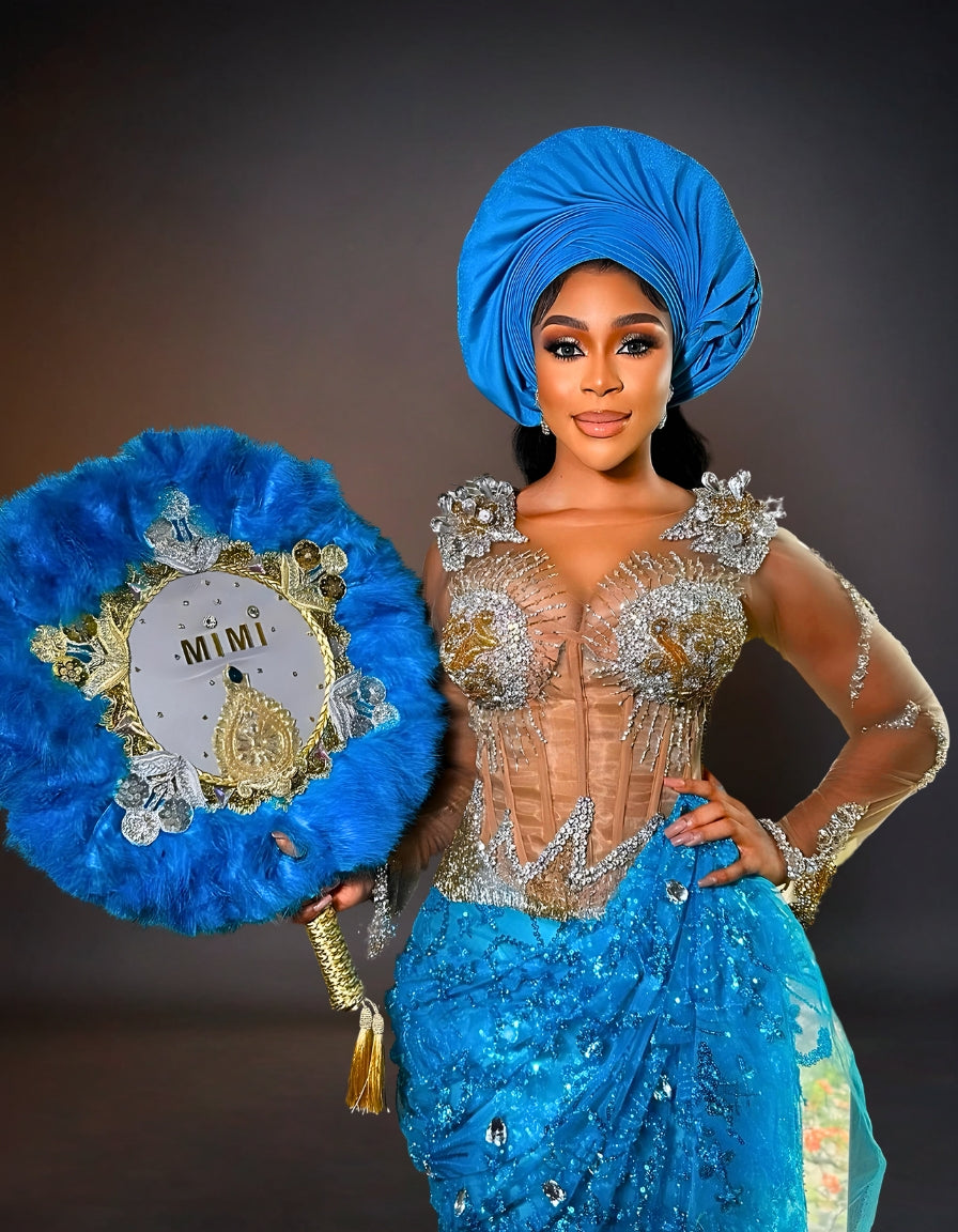 Luxury traditional George lace wedding attire in silver and blue.