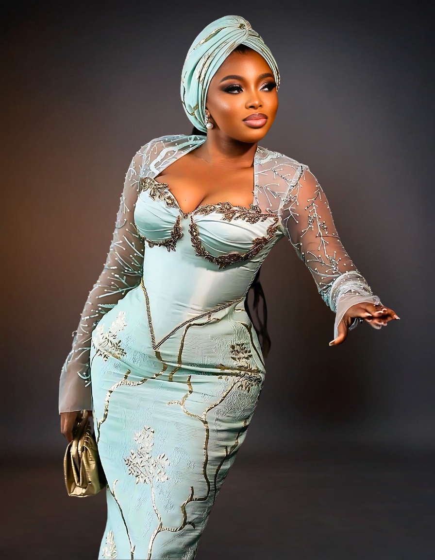 Luxurious Long Sleeve Aso Ebi Dress in Mint Green. The dress features elegant, intricate lace detailing and a fitted silhouette, showcasing a blend of traditional and modern design elements.