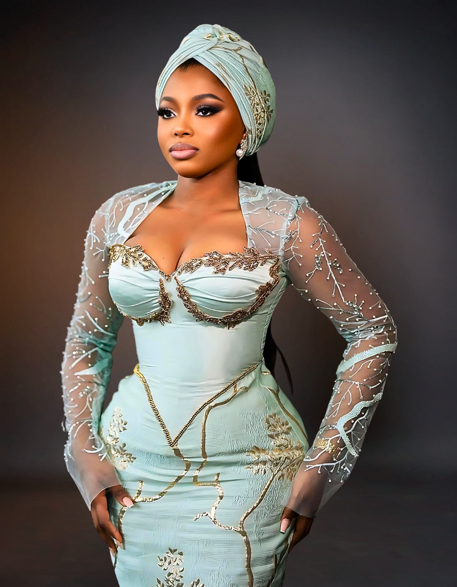 Luxurious Long Sleeve Aso Ebi Dress in Mint Green. The dress features elegant, intricate lace detailing and a fitted silhouette, showcasing a blend of traditional and modern design elements.