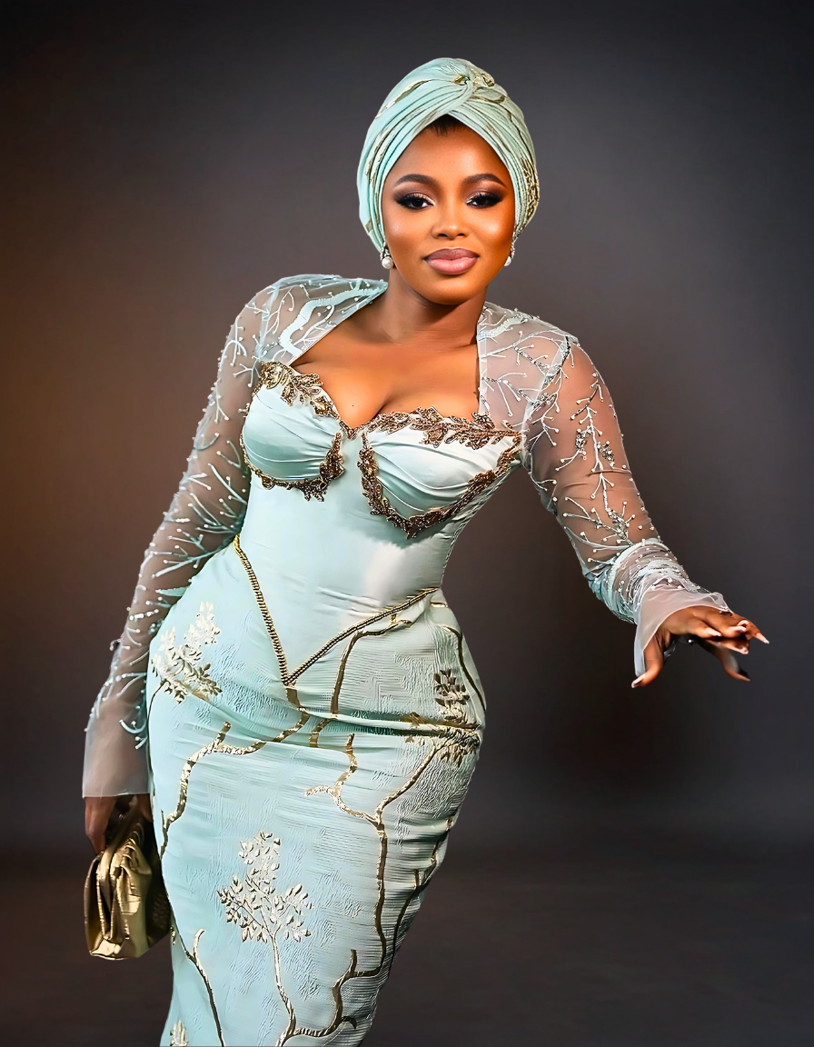 Luxurious Long Sleeve Aso Ebi Dress in Mint Green. The dress features elegant, intricate lace detailing and a fitted silhouette, showcasing a blend of traditional and modern design elements.