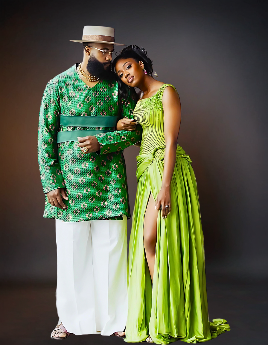 A sophisticated couple is elegantly dressed in coordinating green attire. The woman is wearing a stylish green dress, while the man is dressed in a sharp green shirt..
