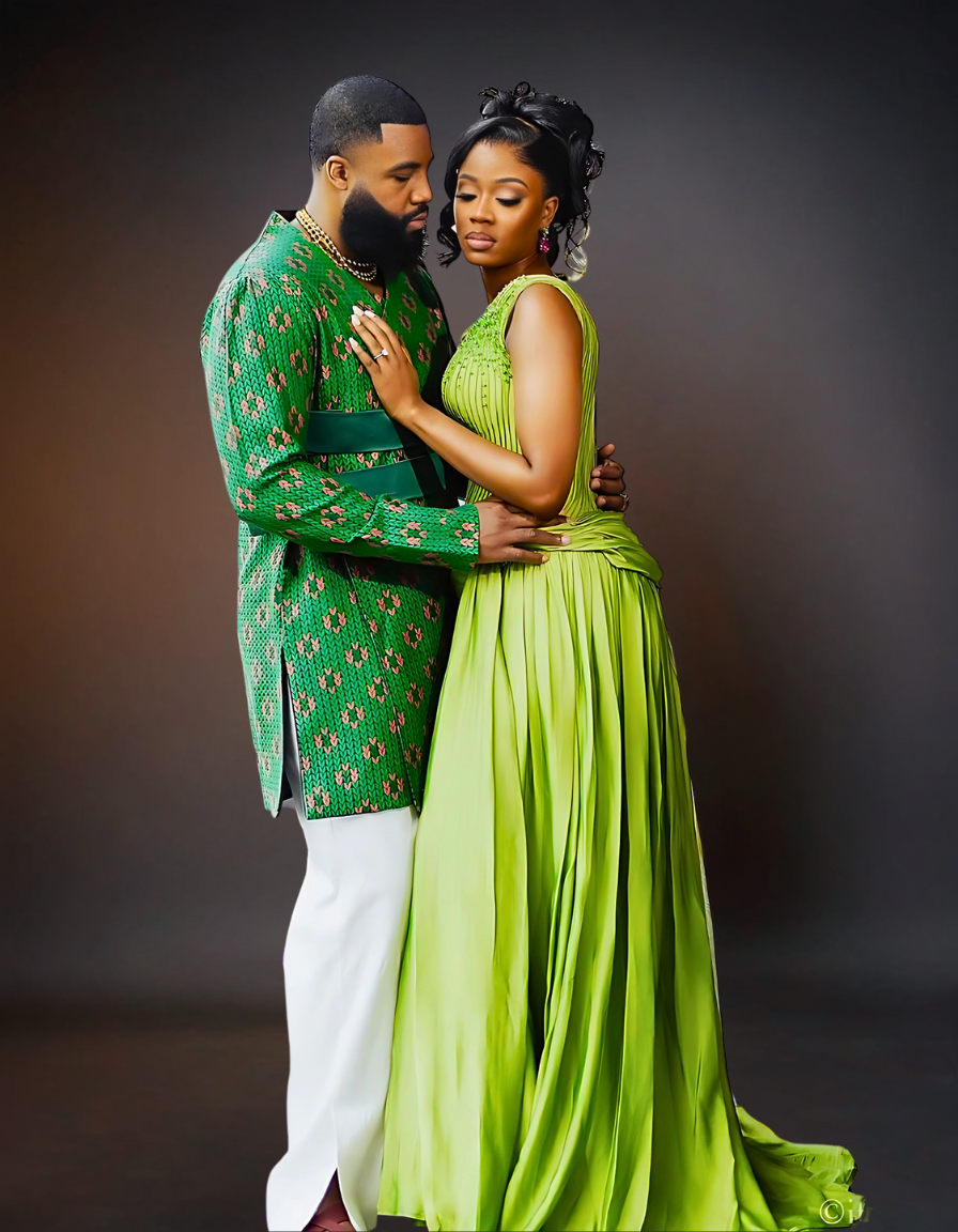A sophisticated couple is elegantly dressed in coordinating green attire. The woman is wearing a stylish green dress, while the man is dressed in a sharp green shirt..
