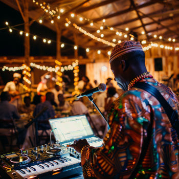 A live band playing traditional instruments, and guests clapping and cheering.