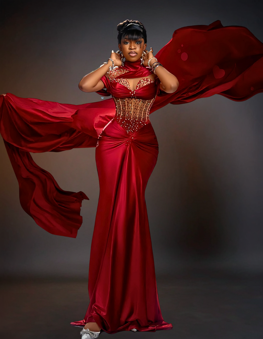 A luxurious long satin prom dress in a vibrant red color, featuring a fitted corset bodice and flowing skirt.