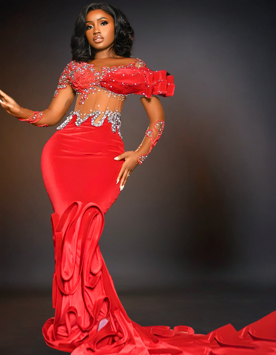 A luxury long red prom mermaid dress with a tail is displayed. The dress features a fitted bodice that flares out at the knees, creating a dramatic, elegant tail. 