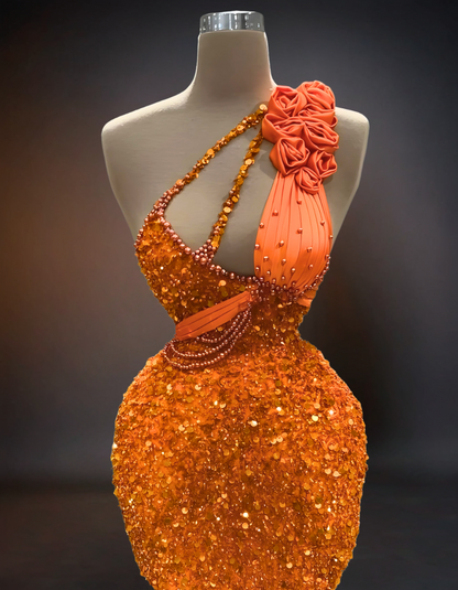 A luxury short prom dress in a vibrant orange color, adorned with intricate beaded lace detailing.