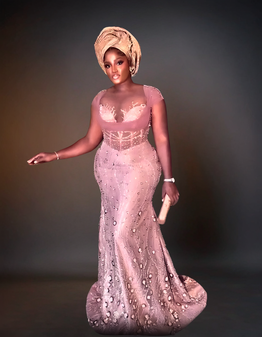 Exquisite nude Aso Ebi wedding party dress featuring intricate traditional designs and luxurious detailing.