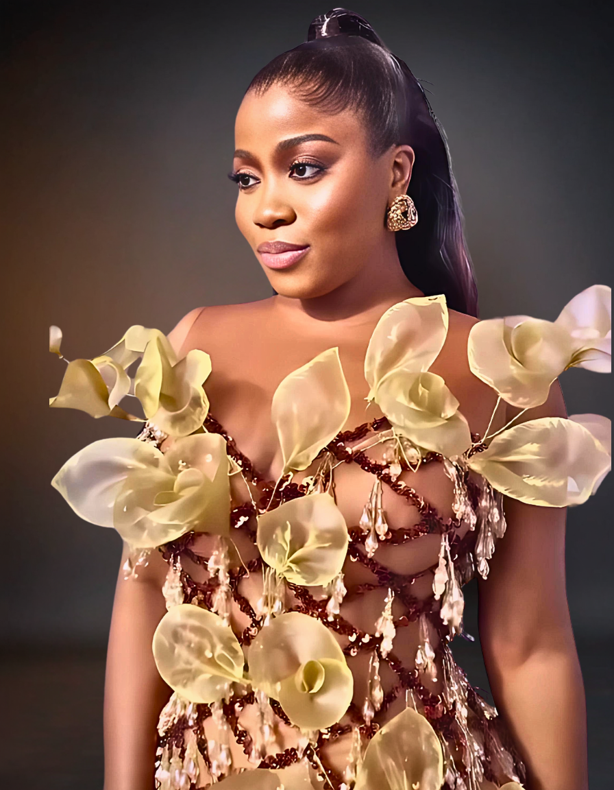 Luxury 3D prom flower dress in brown and gold, featuring intricate floral designs and embellishments, displayed on a mannequin in an elegant setting.