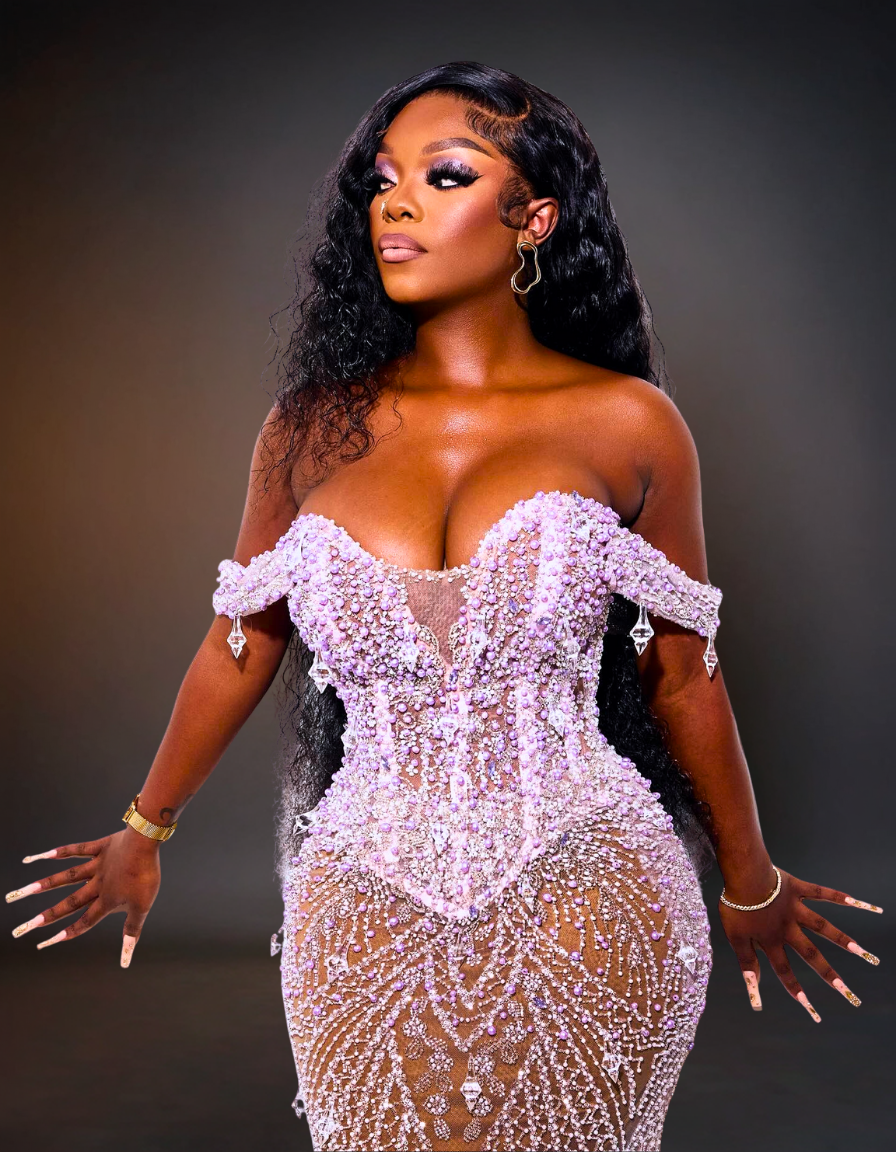 Woman wearing a sparkling silver dress against a dark background