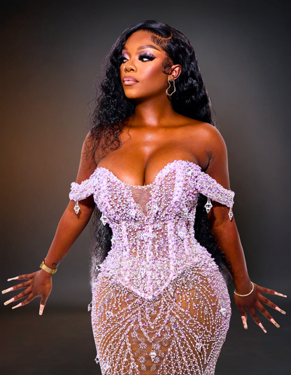 Woman wearing a sparkling silver dress against a dark background