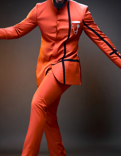 Person wearing an orange suit with black accents on a dark background