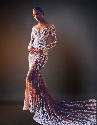 Woman wearing a long, elegant gown with intricate designs against a dark background