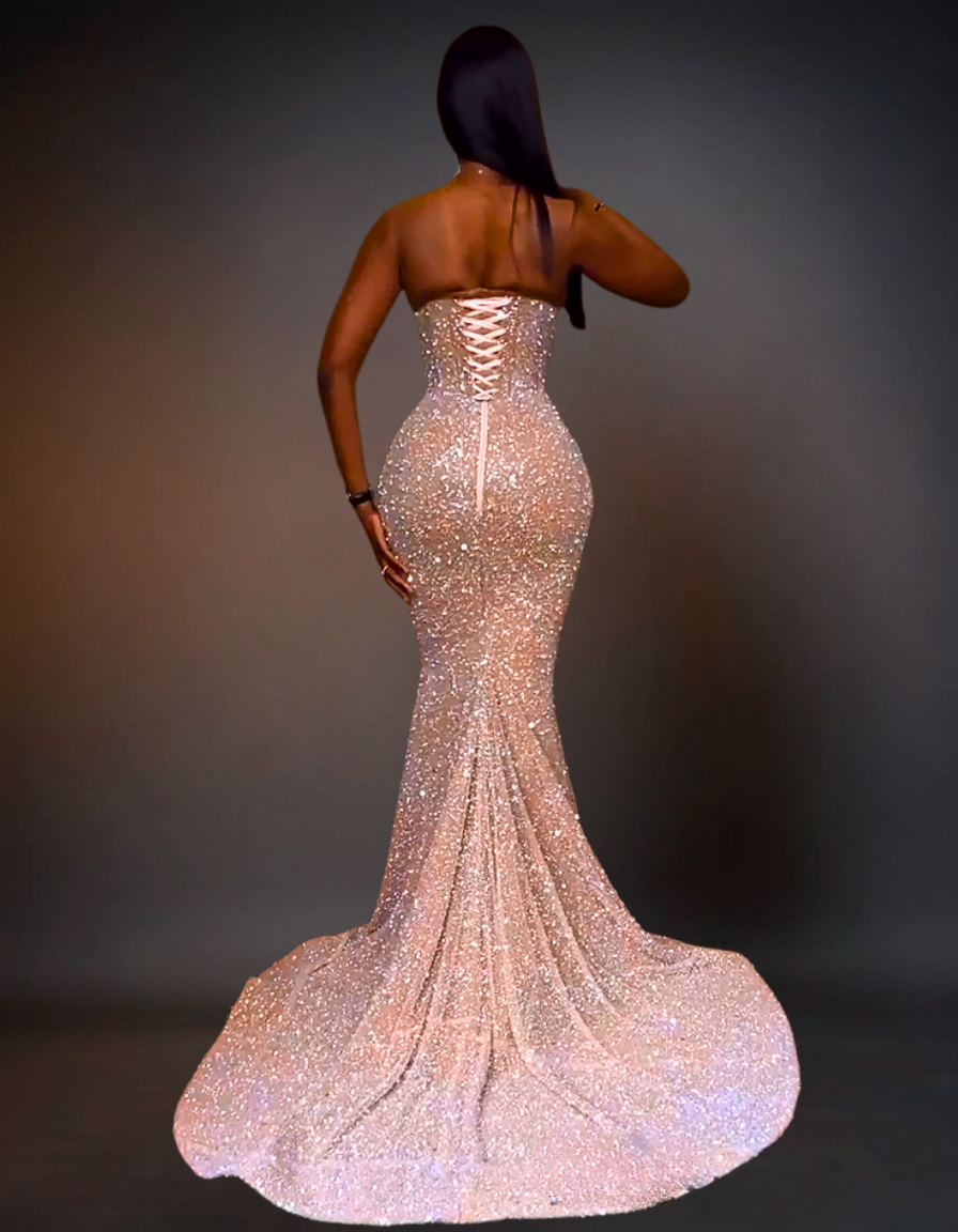 Woman wearing a sparkling evening gown against a dark background
