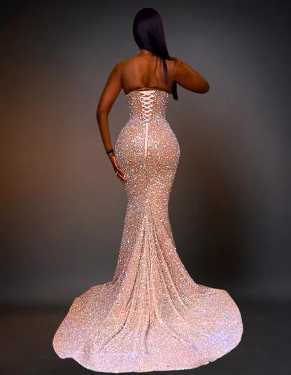 Woman wearing a sparkling evening gown against a dark background