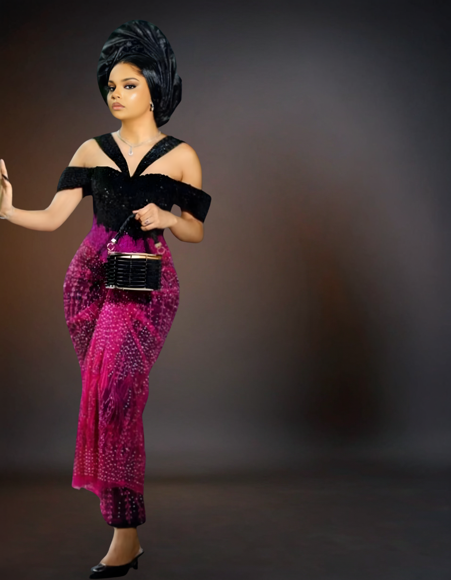 Woman wearing a black and pink dress with a dark background