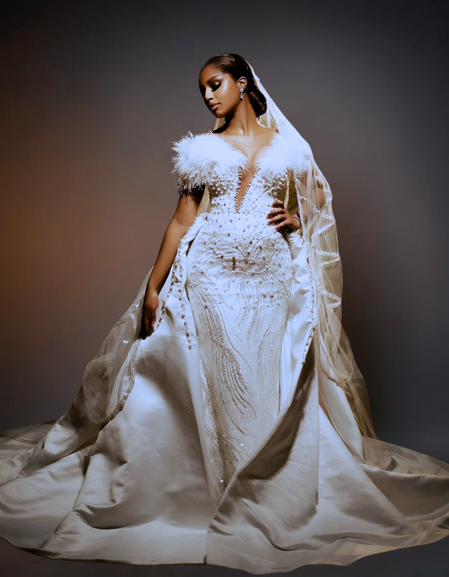 Woman in an elegant white wedding gown with a dark background