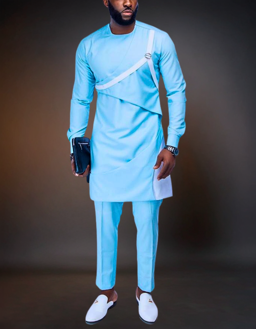 Man wearing a light blue traditional outfit with white shoes against a dark background