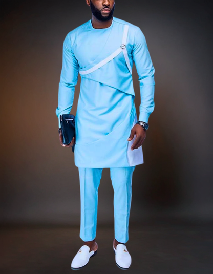 Man wearing a light blue traditional outfit with white shoes against a dark background