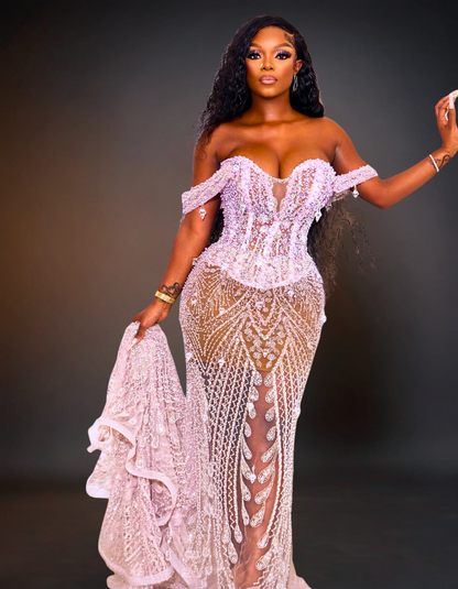 Woman wearing a white lace dress against a dark background