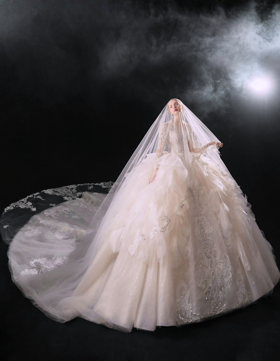 White wedding dress with a long train against a dark background